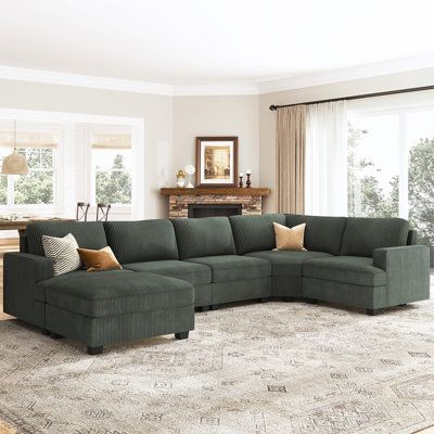 This elegant corduroy sectional couch is a beautiful addition to any living room. Its modern design and neutral color scheme make it versatile enough to fit in with any existing decor, while its large size provides ample seating for entertaining guests or relaxing with family. The couch is made from high-quality materials and is built to last, making it a great investment for your home. Whether you're looking to update your current living room or start fresh in a new home, this couch is sure to Living Room Design Green Sofa, Green Sectional With Ottoman, Dark Sectional Living Room, Green Couch Living Room Colour Schemes, Corduroy Sectional, Forest Green Sectional, Moss Green Sectional Sofa, Dark Green Couches, Corduroy Sectional Couch