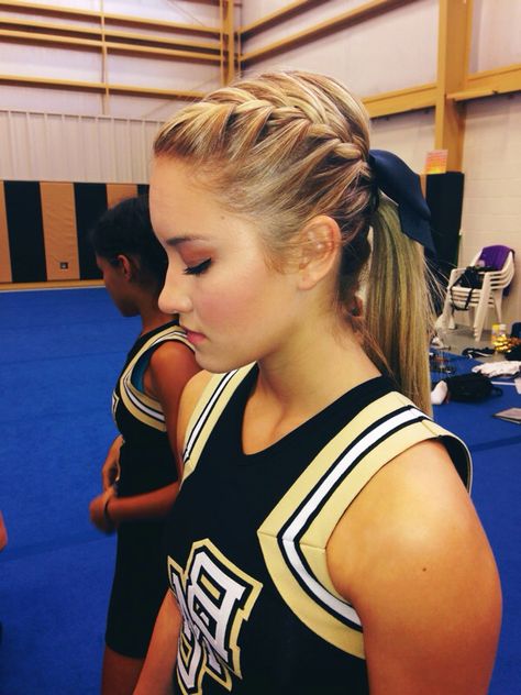 cheer hair Cheer Hair Braids, Dutch Braid Cheer Hair, Ponytail Hairstyles For Cheer, Low Cheer Ponytail With Bow, Football Cheer Hairstyles, Low Pony Hairstyles For Cheer, Cheer Leading Hairstyles, High School Cheer Hairstyles, Low Ponytail Cheer Hair