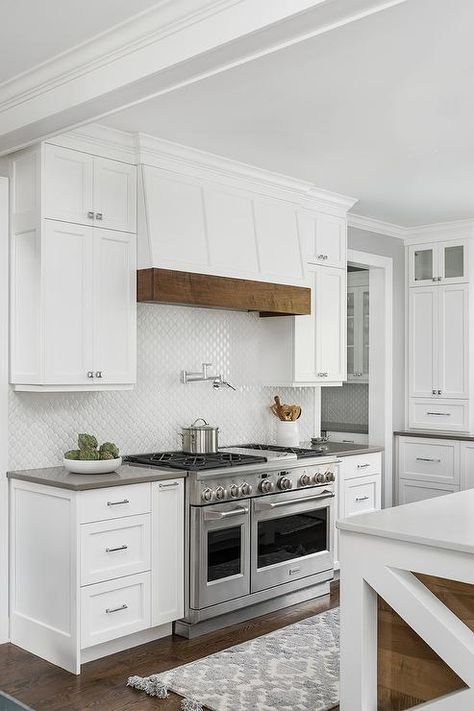 Cottage style range hood features a wood trim above a swing arm pot filler mounted on white arabesque backsplash tiles completing a cooktop design. Kitchen Hood Ideas, Kitchen Hood Design, Kitchen Vent Hood, Kitchen Vent, Kitchen Country, House Farmhouse, Kitchen Range Hood, Kitchen Hoods, Perfect House