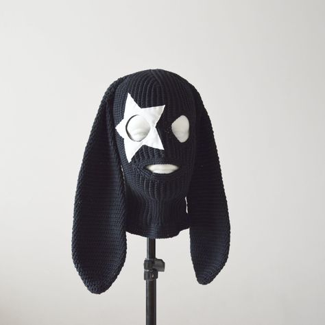 A cool exclusive collection of crochet women's and men's balaclavas in cotton yarn with bunny ears and star is available to order. Crocheted rabbit ski mask in black color. Two eye holes and a mouth hole. A white leatherette star is sewn around the right eye. Limited edition of this model.  Personalization and skilled handwork make each piece unique. Let me know if a different color star is needed or if you would like to change the base color of the hat. Size:  M- 22" - 22 3/8" (55.9 cm-56.8 cm) Bunny Baclava Hat, Star Balaclava, Crochet Bunny Ski Mask, Bunny Ear Balaclava, Crochet Cute Hat, Crochet Bunny Balaclava, Rabbit Ear Beanie, Bunny Ski Mask, Ski Mask Crochet