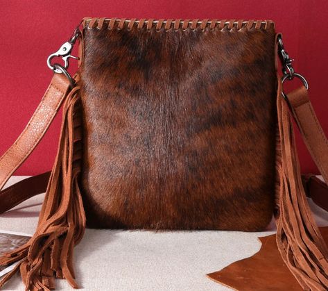 Trinity Ranch line by Montana West, this crossbody has: Genuine hair-on cowhide Leather fringe Whipstitch detail  Top zipper closure Inside zippered compartments have a zippered pocket and an open pocket A zippered pocket on the back to conceal the handgun  (7" x 5") Leather patch logo TRINITY RANCH on open pocket on t Brown Crossbody Bag, Small Crossbody Purse, Aztec Pattern, Leather Fringe, Small Crossbody, Leather Patches, Cowhide Leather, Purses Crossbody, Patch Logo