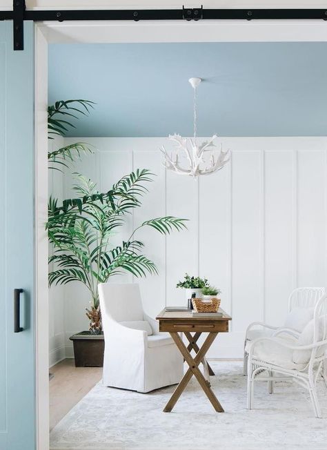 Coastal Office with Blue Ceiling, white rattan accent chairs, wood desk, white slipcover arm chair, corner palm plant via @timbertrailshomes Coastal Office Decor, Coastal Office, Coastal Farmhouse Decor, Blue Ceilings, Farmhouse Dining Table, Coastal Farmhouse, Coastal Chic, Modern Coastal, Farmhouse Dining