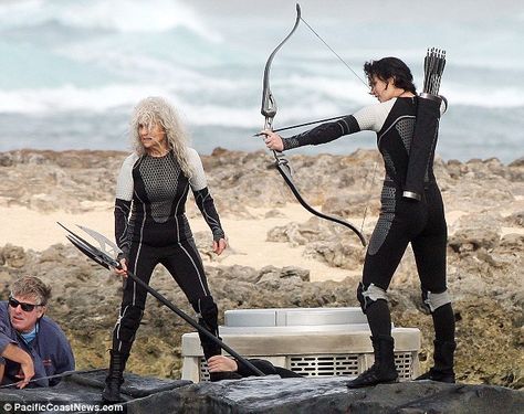 In battle: Later she got to work with some battle scenes, brandishing a bow and aiming at somebody in the water, alongside an older co-star Lynn Cohen, Hunger Games Movies, Hunger Games 3, Hunger Games Series, Peeta Mellark, Mary Sue, Hunger Games Catching Fire, Hunger Games Trilogy, Bow And Arrow