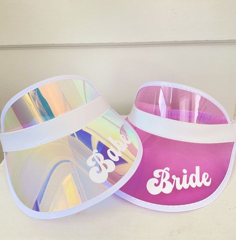 "Personalized Beach Visors are the perfect accessories for your pool or beach bachelorette party! Each holographic visor comes in your choice of Bride, Babe, or a custom name in white vinyl sure to make your bridal party stand out in style. ★DETAILS★ Listing is for 1 Personalized Holographic Visor. No Other Items Included. ★HOW TO ORDER MORE THAN ONE TEXT STYLE★ 1. Choose your style from the drop-down and add each hat to your cart one at a time. 2. Your shipping will automatically combine when o Retro Pool Parties, Bridesmaid Champagne Flutes, Barbie Bachelorette, Bachelorette Pool Party, Bachelorette Beach, Pool Party Favors, Beach Bachelorette Party, Lake Gifts, Bachelorette Party Beach