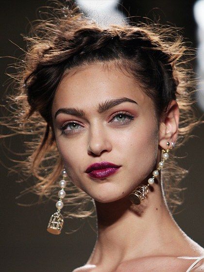 The inspiration behind the look at the Nicole Miller show may have been the eighteenth century, but the deep violet-fuchsia lip color was full-on 2014. (It's undeniably reminiscent of Pantone's color of the year, radiant orchid.) To get it, makeup artist James Kaliardos lined the models' lips with M.A.C. Lip Pencil in Vino, then swiped on M.A.C. Lipstick in Violetta, a bold purple. FOR A SIMILAR LOOK, TRY: 1. Iman Luxury Moisturizing Lipstick in Flirtatious 2. Avon Ultra Color Bold Lipstick i... Casual Lipstick Color, Purple Lipstick Looks, Purple Lipstick Makeup, Violet Lipstick, Lips Shape, Flaming Lips, Bright Lipstick, Bold Lipstick, Dark Lipstick