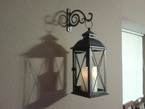 Cheap wall decor idea.   Indoor/outdoor lantern with bracket used for hanging plants Wall Lanterns Indoor, Diy Outdoor Lanterns, Indoor Lanterns, Cheap Wall Decor, Lantern Ideas, Outdoor Lantern, Wall Lanterns, Lanterns Decor, Wall Lantern