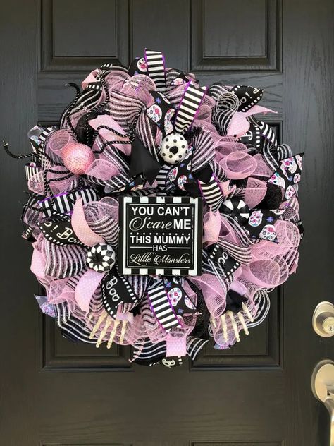 a fun black, pink and white Halloween wreath with lots of mesh ribbons and striped ones, ornaments, donuts and a sign White Halloween Wreath, Pink Halloween Decor, Halloween Fireplace, Polymer Clay Halloween, Halloween Decor Ideas, Halloween Tablescape, Halloween Mantel, Gold Pumpkins, Pretty Halloween