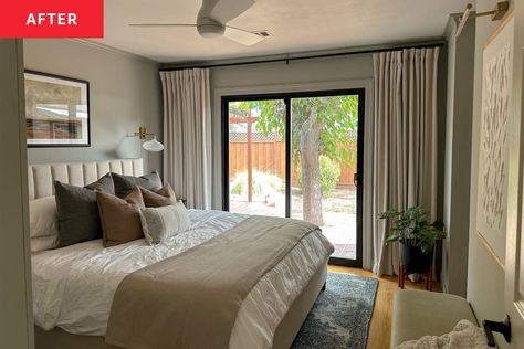 Primary bedroom after renovation: Bed with quilted gray headboard, sliding glass doors letting in light with open pale neutral curtains, pale nuted green walls, framed painting over bed, new built in floor to ceiling closet, small stool with plant on it. Bed has bedding in grays and browns, lots of pillows Master Bedrooms With Sliding Glass Doors, Bedroom With Sliding Glass Door Layout, Bed In Front Of Sliding Glass Door, Small Bedroom With Sliding Glass Door, Bedroom With Sliding Glass Door, Floor To Ceiling Closet, Painting Over Bed, Seafoam Green Bedroom, Pax Hack