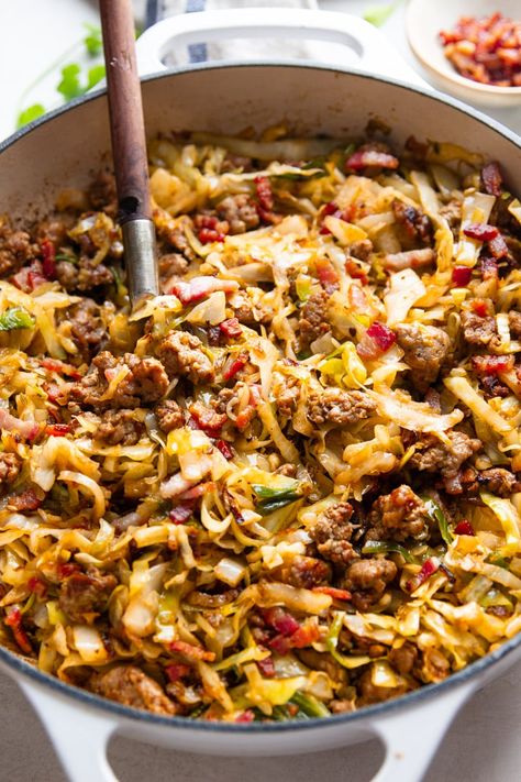 This recipe for Fried Cabbage With Sausage is so simple yet so delicious. Tender chunks of Italian sausage sauteed with onions and fresh cabbage topped with salty bacon bits make this one-pot meal ideal for a busy weeknight. Cabbage Tomatoes And Sausage, Ground Italian Sausage And Cabbage Recipes, Chicken Sausage And Cabbage Recipes, Bratwurst And Cabbage Recipes, Smothered Cabbage And Sausage, Fried Cabbage Recipes Sausage, Ground Sausage And Cabbage, Cabbage With Sausage Recipes, Cabbage Sausage Recipes