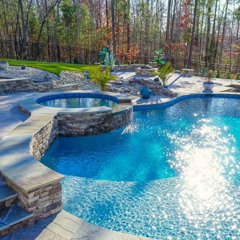 Our "Pittsboro Pool Paradise" project showcases how you can blend nature with design for a beautiful outcome.    This sanctuary features a freeform pool, spa, custom rock waterfall, fire pit, and more. The homeowners were looking to make the most out of the surrounding private landscape that their property offers.   Find more photos and design inspiration at azaleapoolsnc.com! Free Form Pools, Freeform Pool Designs, Pool Paradise, Freeform Pools, Rock Waterfall, Pool Waterfall, Building A Pool, Pool Spa, Pool Designs