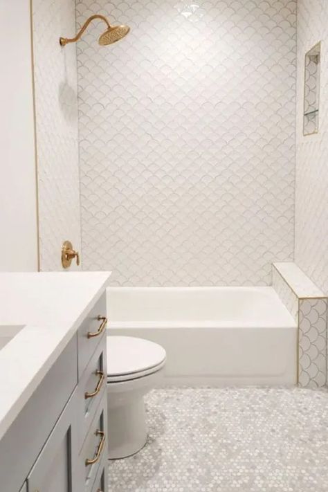 a serene bathroom clad with fish scale tiles and marble penny ones, a tub, a vanity, gold fixtures and a niche shelf Scallop Tile Bathroom, Fish Scale Tile Bathroom, Blue Penny Tile, Niche Shelf, Fish Scale Tiles, Penny Tiles Bathroom, Monochromatic Bathroom, Penny Tiles, Niche Shelves