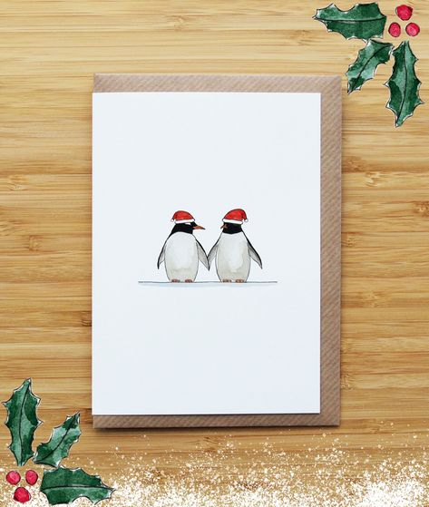 Caption: Penguin Couple. - Original Watercolour and Ink Card by RossJDesigns Add this card to a Christmas multipack: https://www.etsy.com/uk/listing/547982184/christmas-card-multipack - Shipping from Edinburgh, UK - Original watercolour design reprinted on 100% recycled white smooth 300gsm card (FSC approved) OR 100% biodegradable seeded paper (embedded with a mix of wildflower seeds). Cards are handmade, folded and printed by the RossJDesigns team. - Size A6 Card (148x105mm - around 5 7/8 x 4 1/8 inches) - Cards are blank inside and come with a recycled kraft envelope - Items will be posted in a hard backed envelope - Plastic free packaging (as much as possible) - 10% of profits donated to planting trees and supporting sustainable projects - I only provide tracked shipping for large order Watercolour Pencil Christmas Cards, Christmas Cards For Boyfriend, Christmas Card Boyfriend, Couples Christmas Card, German Christmas Cards, Penguin Christmas Cards, Watercolour Christmas Cards, Boyfriend Christmas Card, Winter Karten