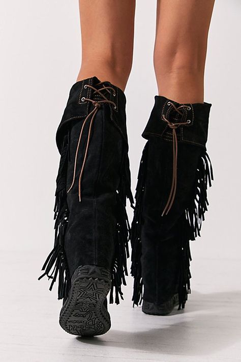 Italian made suede moccasin inspired boots featuring an over the knee fit, fringe trim and belted details. * Lace-up back * Padded insole | Drifter Tall Mocc Boots by El Vaquero at Free People in Grey, Size: EU 39 Black Fringe Cowboy Boots, Fringe Boots Outfit, Fringe Clothes, Tassel Boots, Fringe Clothing, Fringe Shoes, Moves Like Jagger, Moccasin Boots, Fringe Boots