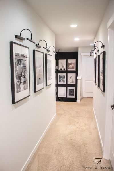 Spruce up your boring hallway with this Black and White Hallway Gallery Wall using personal pictures and wireless sconces! #hallwaydecor #hallwayideas #gallerywall Black And White Hallway, Beige Hallway, Hallway Pictures, Hallway Gallery, Hallway Gallery Wall, Gallery Wall Staircase, White Hallway, Staircase Makeover, Gallery Lighting