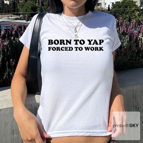 📣 Calling all chatterboxes and style mavens! 🌟 Introducing the cheeky and chic "Born to Yap Forced to Work Baby Tee" by printwithsky! This isn't just any tee; it's a statement of your playful spirit wrapped in the comfort of 100% cotton. 🌿 #Y2KAesthetic #GirlPower #babytee #printwithsky #streetwear #trendytop #GraphicTee #BabyTee #pinterestinspired #londonfashion #londonstyle #lafashion #lastyle #nycstyle #nycfashion #springinspo #summeroutfit #summerinspo #90s #90sfashion #ootdfashion #dis... Funny Baby Tees, 90s Baby, Trendy Top, Baby T Shirts, Fitted Tee, Large Shirts, Funny Baby, Y2k 90s, Trendy Tops