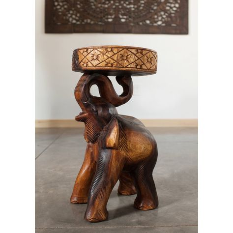 The elephant (Chang in Thai language) end table with eco friendly natural, food-safe livos walnut oil finish presents a hand carved rendition supporting a round flat surface. All wood used is from sustainable monkey pod wood sources, and all products use eco-friendly Livos finishing oils. This elegant hand carved functional work of art can serve as an end table, display stand, or pedestal. Each is hand carved from a single piece of wood. Appealing to the viewer from any angle, each is more th... Wood Figurine, Handmade Stool, Elephant Table, Monkey Pod Wood, Walnut Oil, Sofa End Tables, Wood End Tables, Table Stool, End Tables With Storage