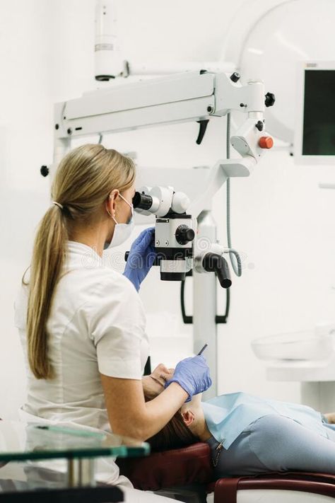 Female dentist using dental microscope treating patient teeth at dental clinic office. royalty free stock photography Dentist Photography, Dental Esthetics, Clinic Office, Female Dentist, Dental Photography, Dentist Office, Dental Lab, Stock Photography Free, Dental Clinic