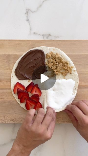 Kelly Senyei | Just a Taste® on Instagram: "TORTILLA WRAP HACK: S’MORES EDITION! 🔥

Bring the s’mores indoors by sandwiching marshmallow fluff, crushed graham crackers, creamy Nutella and sliced strawberries inside a tortilla. Toast it in melted butter then give it a good cinnamon-sugar shower for summertime flavor in every bite! 🙌🏻

👉🏻 COMMENT with the word TORTILLA and I’ll DM you the clickable recipe link for all of my wrap hack variations!

#tortilla #cookinghacks #smores #smoresseason #nutella #tortillawrap #smore" Healthy Snack Hacks, Movie Night Healthy Snacks, Movie Night Appetizers, Tortilla Wrap Hack, Instagram Desserts, Smores Dessert, Smore Recipes, Tortilla Wrap, Snack Hacks