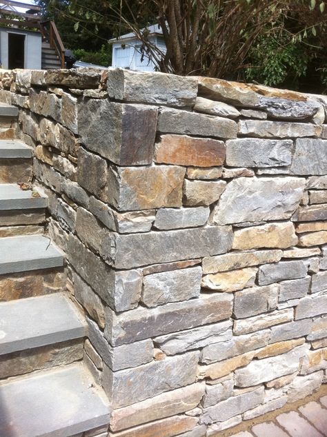 Stacked stone walls give you plenty of height where you need it, such as in this example when the wall extends the full height of the steps. Stone Perimeter Wall, Modern Italian Farmhouse, Stone Walls Garden, Stacked Stone Walls, Stone Garden Paths, Eco House Design, Compound Wall Design, Stone Landscaping, Privacy Fence Designs