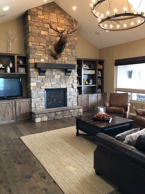 The combination of wood floors and stone fireplace add richness to this rustic inspired home. Rustic House Living Room, Slate Fireplace Surround, Black Fireplace Surround, Wood Burning Stoves Living Room, Cottage Fireplace, Slate Fireplace, Stone Fireplace Surround, Natural Stone Fireplaces, Stone Fireplaces