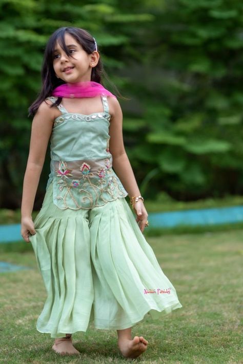 Shop online for Indian ethnic wear for your little ones Our designing lays emphasis on embroidery and hand-work primarily.An intricately coordinated costume, handcrafted with minutely detailing work of art.
 A piece of several thoughts and ideas ensembled with love, for your little princesses. Customization available, sleeves can be added. Organza Kurta, Kids Indian Wear, Designer Dresses Elegant, Churidar Neck Designs, Green Hand, Ethnic Dress, Kids Swimwear, Indian Ethnic Wear, Churidar