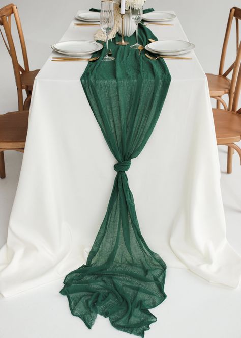 Emerald Green table runner is elegant and sophisticated. Cheesecloth looks absolutely gorgeous as centerpiece table runner or wedding arch decoration. ♥ Place it in the center of the table, don't forget to make relaxed fabric waves, put some candles and flowers on it and enjoy a beautiful rustic style. ♥ You can use cheesecloth as a table runner, tieback for chair or wedding arch decoration. Also, it can be used as a scarf or baby shower decoration. Endings of our cheesecloth are raw (rustic unf Emerald Green Cheesecloth Table Runner, Emerald Table Runner, White Tablecloth Emerald Green Runner, Emerald Green Silver Wedding, Hunter Green Table Cloth Wedding, Emerald Green Quinceanera Theme Wedding Table Decor, Emerald Green Outdoor Wedding, Dark Green Table Runner, Green Cheesecloth Table Runner Wedding