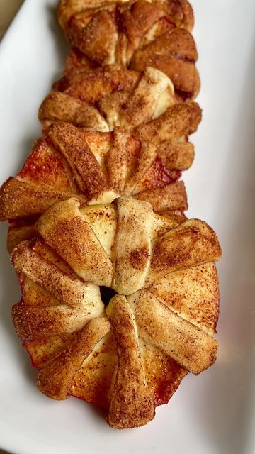 Genien on Instagram: "Apple pie rings Follow @genie_cooks for more! This is my favorite apple pie hack it’s so simple! 4 large apples 1 package crescent rolls 1 tbs sugar 1 tsp cinnamon Core apples then slice into 1/4 inch thick rings. Slice crescent rolls into strips and wrap the strips around the apple rings. In a separate bowl combine the cinnamon and the sugar then take the apple rings and coat them in the cinnamon sugar. Place them onto a baking sheet and bake 375° 18-20 minutes until Apple Pie Ring Crescent Rolls, Apple Slice Crescent Rolls, Apple Rings Wrapped In Crescent Rolls, Baked Apple Pie Rings, Apple Slices Wrapped In Crescent Rolls, Apple Rings With Crescent Rolls, Apple Pie Rings With Crescent Rolls, Apples Wrapped In Crescent Rolls, Apple Rings With Pie Crust