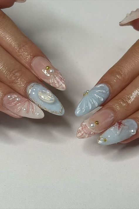 Beach nails in a soft blue color reminiscent of the ocean, adorned with shells and starfish, and accented with pink and white 3D shells by @gelxbysum (IG) create a dreamy and vibrant manicure. This design combines serene ocean hues with playful beach motifs and detailed 3D elements, offering a fresh and charming look perfect for summer. Explore a collection of stunning beach nail ideas on Nailustrous and get inspired for your perfect summer manicure! Beach Nail Ideas, Best Nail Colors, Vacation Nails Beach, Festive Holiday Nails, Beach Nail Designs, Beach Nail, Ocean Hues, 3d Elements, Fun Nail Colors