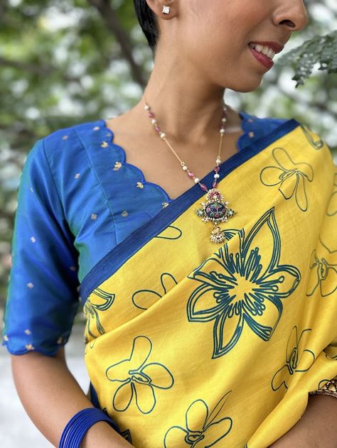 Peacock blue kanchi silk blouse -Discover the exquisite charm of our handwoven Kanchipuram silk blouse, a blend of tradition and elegance. Crafted with love, this blouse features pure zari buttas intricately woven into a dual-toned peacock blue fabric. The front showcases a scalloped V-neck, while the back is a sophisticated high neck design. The scalloped detailing is repeated along the sleeves, highlighted with subtle zari embroidery, adding a touch of finesse to this timeless piece. Perfect for festive occasions, weddings, and traditional celebrations, this Kanchipuram silk blouse is a must-have addition to your ethnic wardrobe. To view more similar blouses, pls click on https://aavaranaa.com/blouses/ High Neck Designs, Peacock Blue, Unique Designers, Silk Blouse, Blue Fabric, Neck Designs, Saree Designs, Timeless Pieces, Blouse Designs