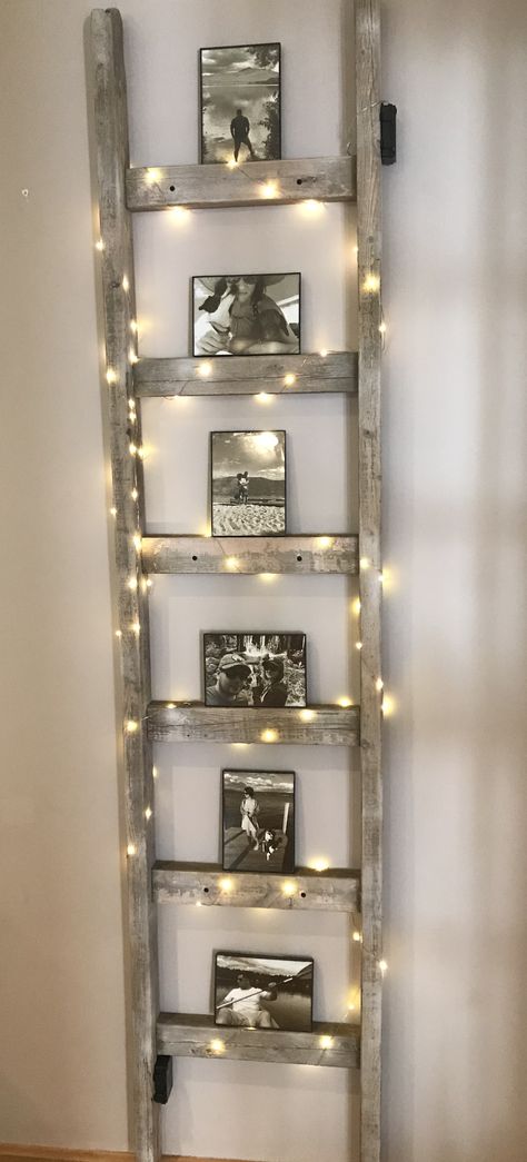 Inside Ladder Decor, Ladders With Lights, Decorating Ideas For Old Wooden Ladders, Ladder On Wall Decor, Old Ladder Wall Decor, Wooden Ladders Ideas Decor, Old Ladder Light Fixture, Decorative Ladder Ideas, Blanket Ladder Living Room