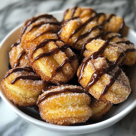 Baked Churro Bites 🥐🍫 Ingredients: 1 sheet puff pastry, thawed 1/4 cup melted butter 1/2 cup granulated sugar 1 tsp ground cinnamon Chocolate sauce or caramel, for dipping Instructions: Preheat oven to 400°F (200°C). Line a baking sheet with parchment paper. Roll out the puff pastry sheet and cut into small bite-sized squares. Arrange the pastry squares on the baking sheet and bake for 10-12 minutes, until golden and puffed. In a bowl, mix together the sugar and cinnamon. Once the churro bite... Churro French Toast Bites, Easy Churro Bites, Mini Churro Cheesecake Bites, Sweet & Salty Churro Bites, Churro Snacks 12 Tomatoes, Churro Bites, Puff Pastry Sheets, Pastry Sheets, Chocolate Sauce