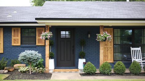 Welcome to the CC and Mike Modern Navy and Cedar Ranch Style Remodel Reveal! This flip house was originally started as a project for an HGTV pilot. They passed but this home was one of our favorites! Black Siding Exterior Ranch Style, Dark Blue House With Cedar Shutters, Navy Painted Brick House Exterior, Navy Blue House Exterior White Trim Wood Accents, Navy House Wood Shutters, Painted Blue Brick House Exterior, Navy Blue Homes Exterior, Dark Navy House Exterior Black Trim, Navy Painted Brick House