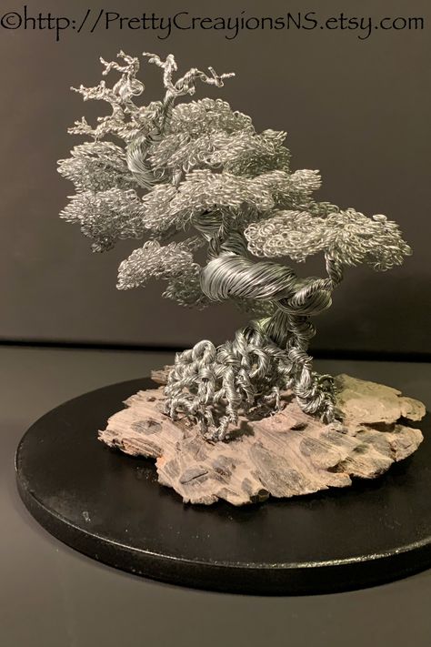 This wire bonsai is made in the informal upright style. It is handmade of aged steel wire, with an intricate exposed root system that flows into a very twisted trunk, branches and leaves. 6.5”H 6.5”L 5.5”D metal bonsai tree/wire tree/wire bonsai/bonsai/wire tree sculpture/metal tree/wire bonsai/home decor/mindfulness gift/office decor/minimalist art/wire art/wire bonsai tree/handmade Wire Bonsai Tree, Bonsai Wire, Iron Sculpture, Wire Bonsai, Wire Tree Sculpture, Wire Trees, Art Wire, Copper Wedding, Galvanized Iron