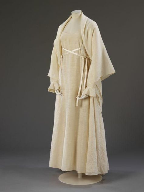 This ensemble was designed as an ecological wedding dress. The concept of the outfit was that multiple versions would be made to be lent to brides free over the period September 1996 to June 1997. Each dress was intended to be returned after having been worn. Over 200 people took part in the project, involving 65 dresses. The dresses were available in a variety of sizes and styles to suit a wide range of figures Wedding Headdress, Hemp Fabric, Groom Outfit, Wedding Sandals, Natural Silk, Design Museum, Victoria And Albert Museum, Silk Ribbon, Natural Fabrics