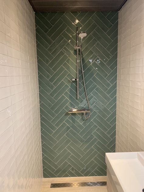 Green Chevron Tile Bathroom, Dark Green Herringbone Tiles, Green Herringbone Shower Tile, Dark Green Herringbone Tiles Bathroom, Sage Herringbone Tile Bathroom, Herring Bone Tiles Bathroom, Bathroom With Herringbone Tile, Herringbone Shower Accent Wall, Green Tiles Toilet