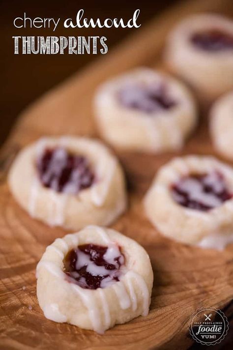 Cherry Almond Thumbprints pair the delicious flavors of cherry preserves and almond to make a buttery shortbread cookie that is perfect for the holidays. #thumbprints #thumbprintcookies #cherry #almond #easy #recipe #jam #christmas #iced #best Meltaway Cookies, Cherry Preserves, Christmas Food Treats, Cherry Cookies, Buttery Shortbread Cookies, Raspberry Almond, Cherry Almond, Almond Flavor, Thumbprint Cookies