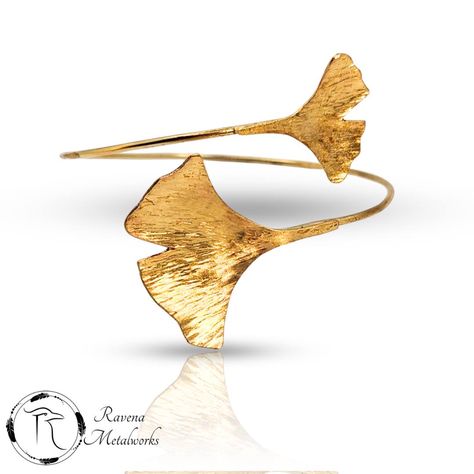 Elevate your style with the elegant Ginkgo Leaf Wrap Bangle, handcrafted in brass. This exquisite piece features a beautifully sculpted ginkgo leaf design, symbolizing resilience and harmony. Each bangle is meticulously crafted to capture the delicate, organic texture of ginkgo leaves, making it a timeless addition to any jewelry collection. _ #RavenaMetalworks #FallLeaves #GinkgoLeaf #GinkgoJewelry Ginko Jewelry, Brass Jewellery, Ginkgo Leaves, Wrap Bangles, Dragonfly Earrings, Ginkgo Leaf, Jewelry Tags, Black Feathers, Brass Jewelry