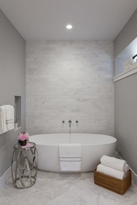 A white and gray master bathroom featuring an egg-shaped tub boasting a gorgeous accent wall tiled in marble. Tub Alcove, Tile Accent Wall, Shiplap Bathroom, Bathroom Accent Wall, Master Bathrooms, Bathroom Accents, Bath Tubs, Farmhouse Modern, Bathroom Design Inspiration