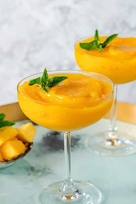 Frozen Mango Daiquiri - Looking for a tropical cocktail? Try this fresh-tasting frozen mango daiquiri with a healthy splash of rum. Made with mango, lime juice, sugar, rum, ice | CDKitchen.com Mango Daiquiri Recipe, Mango Daiquiri, Mango Cocktail, Daiquiri Recipe, Slushie Recipe, Birthday Vibes, Cherry Smoothie, Frozen Mango, Fruit Toppings