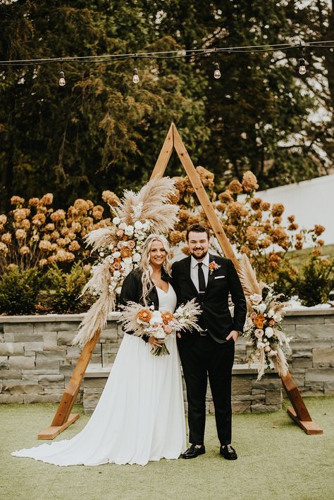 Santé Events & Rentals Triangle Wedding Arch | Photography: Ali Leigh Photography #trianglearch #weddingbackdrop #ceremonyarch #pampas #mnbride #huttonhouse Triangle Wedding Arch Pampas, Boho A Frame Arch, Triangle Boho Arch, Wedding Triangle Arch With Drapes, A Frame Wedding Arch, Triangle Arch Wedding, Pallet Headboards, Arbor Flowers, Arch Photography