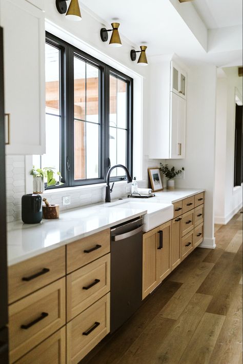 Black Countertops Wood Cabinets Modern, White Cabinets Black Windows, Wooden Cabinets With Black Handles, Modern Natural Wood Kitchen, Black Kitchen Window Over Sink, Wood Upper Cabinets Painted Lower, White Countertops Wood Cabinets, Kitchen Cabinets Around Window, Wood Cabinets Black Countertops