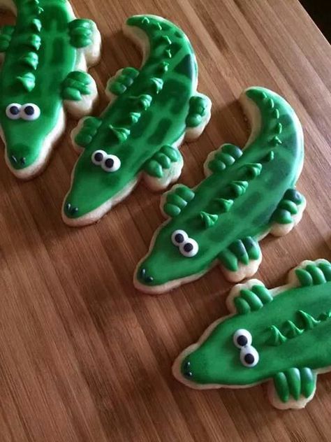 Cajun Christmas alligator cookies Gator Cookies, Alligator Dessert, Reptile Cookies, Alligator Cookies, Crocodile Cookies, Crocodile Cookies Decorated, Florida Gators Cookies, Florida Cookies, Alligator Party Ideas