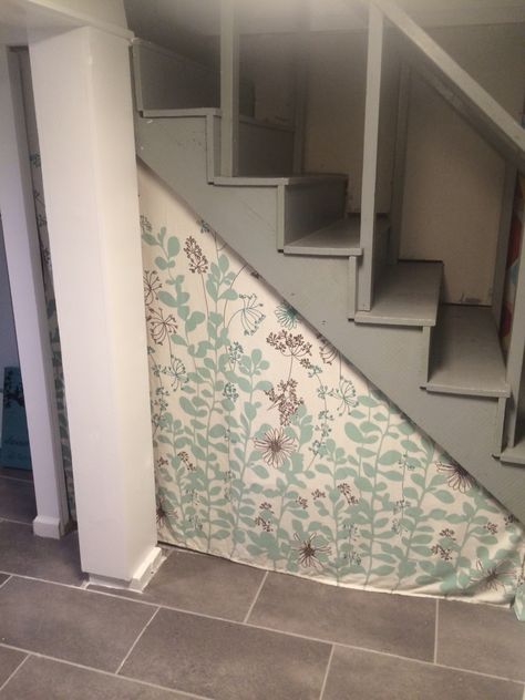 Ways to hide unsightly basement storage under staircase Hide Under Stairs Storage Curtain, Under Stairs Curtain, Curtain Under Stairs, Hide Duct Work In Basement, Under Basement Stairs, Storage Under Staircase, Stairs Covering, Basement Steps, Storage Totes