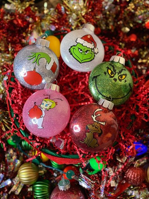 Tis the Season to Deck your Tree with these Custom Grinch Inspired 5 Piece Ornaments These are 3 x 3.5 ornaments. Comes with 5 Custom Ornaments, The Grinch Face, The Grinch hand, Max, Cindy Lou Who, Santa Grinch Accent your tree with just the right amount of this classic favorite! Get into the The Grinch Hand, The Grinch Face, Nightmare Before Christmas Ornaments, Grinch Hand, Grinch Decorations, Grinch Christmas Party, Whoville Christmas, Grinch Christmas Tree, Grinch Christmas Decorations