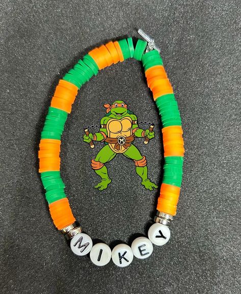 Michelangelo (TMNT) Heishi Bracelet #handmadebracelet #heishibracelets #beadedbracelets #bracelets #personalizedbracelets #personalizedbracelet #raphael #raphaeltmnt #tmnt #tmntraph #teenageninjamutantturtles #teenageninjaturtles #Michelangelo #tmntmikey Tmnt Bracelet, Clay Beads Ideas, Michelangelo Tmnt, Raphael Tmnt, Tmnt Mikey, Clay Bracelets, Heishi Bracelet, Bracelets Ideas, Turtle Bracelet