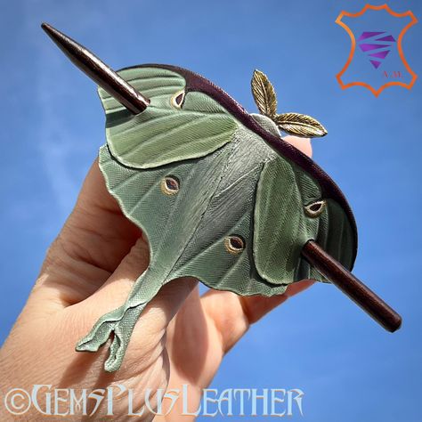 This tooled leather Luna moth was added to my Etsy shop GemsPlusLeather as another sample of my work 🙃 #HairBarrette #hair #hairclip #leathertooling #artisan #tooledleather #accessories #art #jewelry #accessoriesforwomen #lunamoth #artist #gemsforall #etsy #gemsplusleather #custommade #handmadewithlove #handmadewithlove❤️ #customleather #customorder #etsyshop #leather #luxury #etsyseller #madebyme #imadeit #etsysellersofinstagram #etsyfinds #leathercraft #leatherwork Tooled Leather Lapels, Tooled Butterfly, Tooled Leather Claw Clips, Tooled Leather Butterfly, Tooled Leather Hair Barrette, Leather Accessories Diy, Hair Cuffs, Leather Leaf, Luna Moth