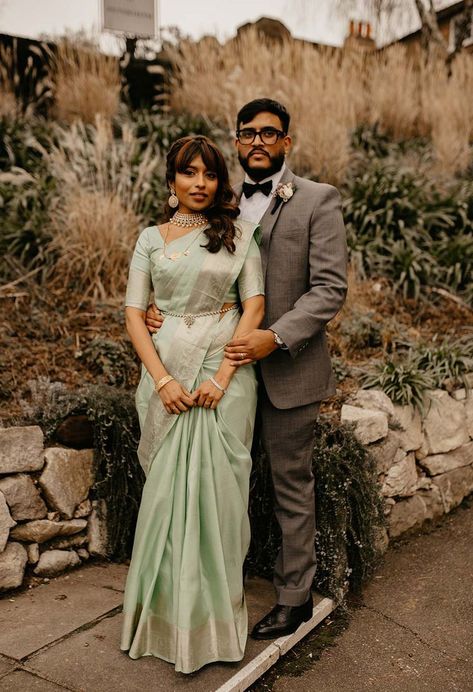 Bride in mint green traditional saree with gold jewellery with groom in grey suit and black bow tie for hotel wedding in London | city wedding Saree With Gold Jewellery, Green Traditional Saree, Mint Saree, Mint Green Saree, Diverse Wedding, Combination Dresses, Grey Suit Jacket, Groomsmen Outfits, Reception Look