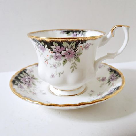 Royal Choice Series Royal Albert tea cup and saucer Bone China from England.  A lovely purple pattern with black back drop and red berries.  Measures approximately 5.5 inch diameter wide gold trim scalloped edge saucer and 2.75 inch tall cup, 3.5 inch diameter with 4.5 inches width at the top with handle.  The set is very clean with no staining, chips or cracks and is ready to use or to be put on display. Yea Cup, Flower Teacup, Vintage Tea Cups, Tea Cup, Tea Set Display, Purple Tea Cups, Fancy Tea Cups, Royal Albert Tea Cup, Tea Cup Collection