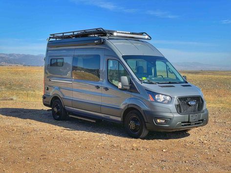 Ford Transit Campervan Conversion with gorgeous wood floors, Flarespace flares, Aluminess roof rack, beautiful accent colors, Birch ceiling, a hidden toilet, heater, 20-gallon water tank, on-demand shower and many more features that enable it to go anywhere, anytime. Transit Van Conversion, Ford Transit Camper Conversion, Transit Conversion, Ford Transit Conversion, Ford Transit Campervan, Hidden Toilet, Custom Camper Vans, Ford Transit Camper, Transit Camper