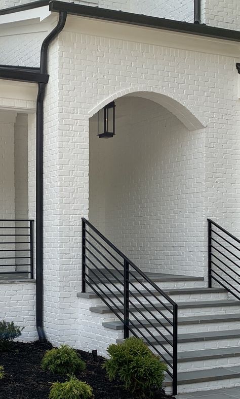 Black and white brick arch with slate steps White Brick Steps Front Porch, Black Brick Steps, Front Entrance Stairs Outside, White Brick Porch, Black And White Brick House, Outdoor Railings For Steps, Slate Steps, Modern House Black, Brick Farmhouse Exterior